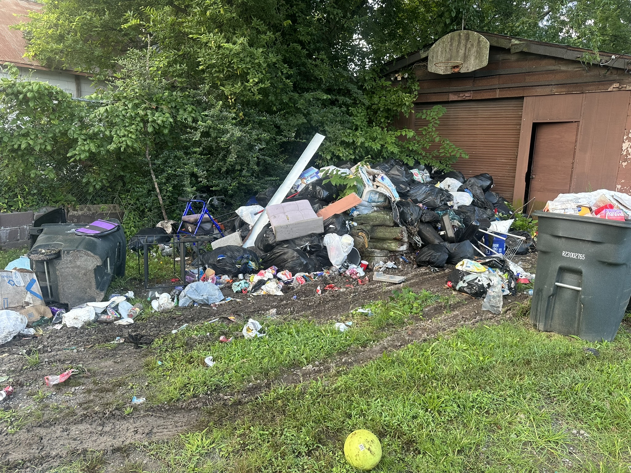 Outdoor debris and bagged rubbish at a property cleanup job